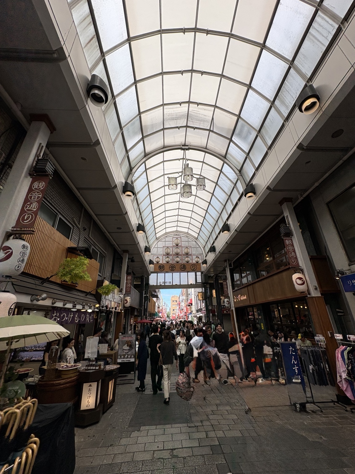 People walking beneath the covered arcade of Kannon-dori in Asakusa