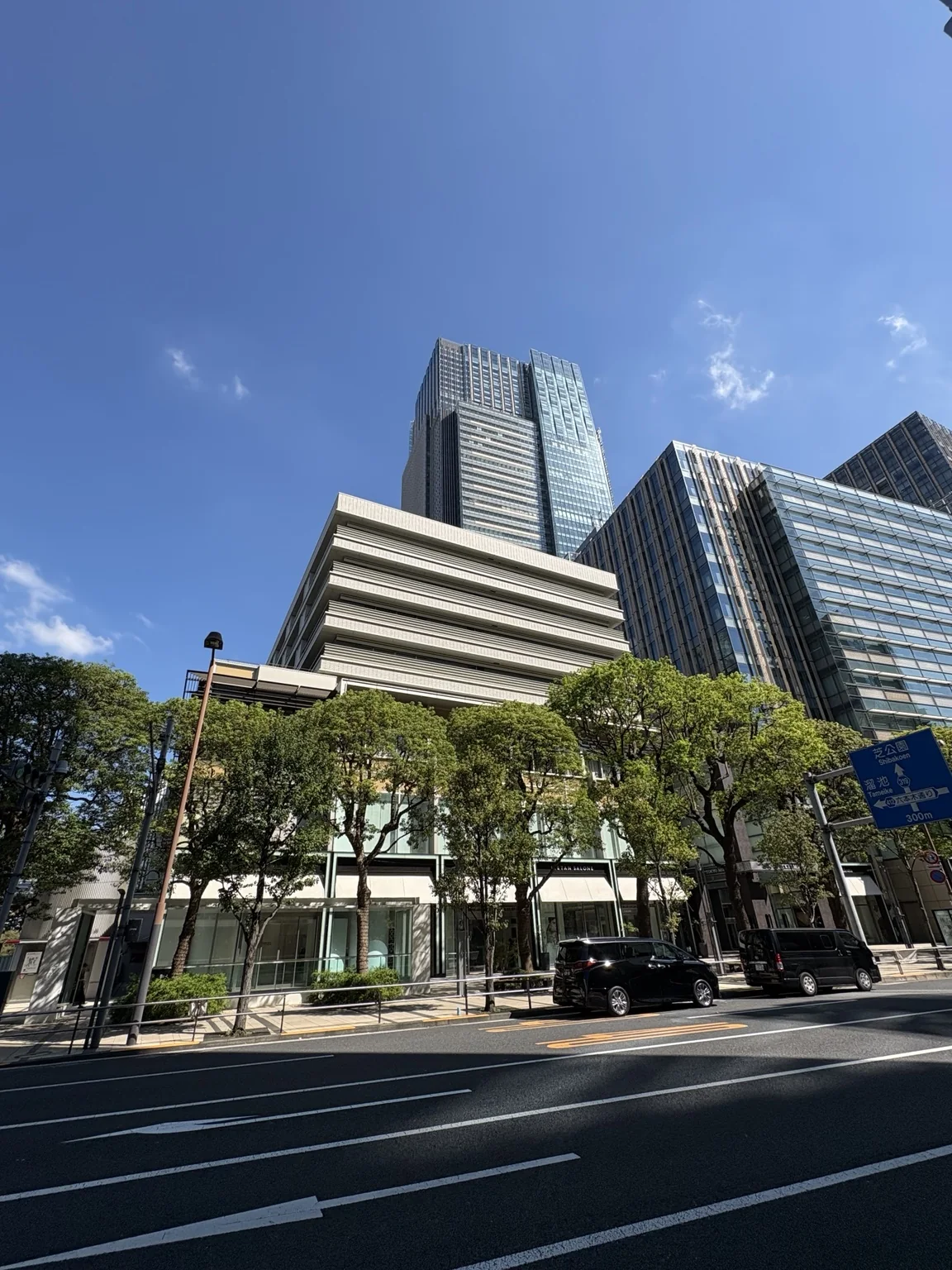 Tokyo Midtown towers rising above a tree-lined street in Roppongi
